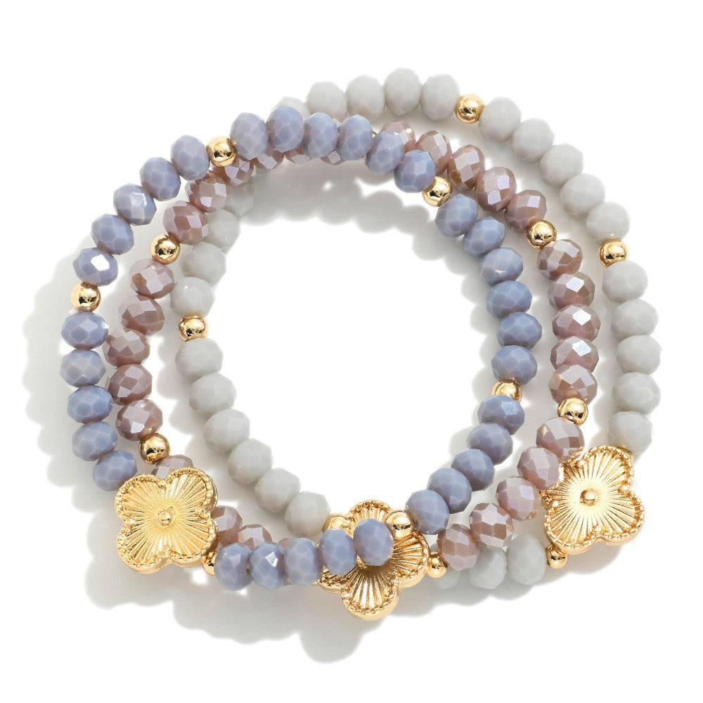 Set Of Three Beaded Stretch Bracelets Featuring Metal Tones, Faceted Beads, & Clover