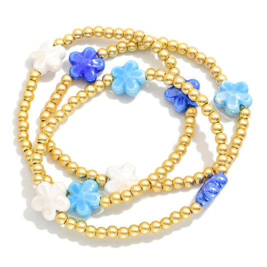 GOLD BRACELT SET OF 3 WITH BLUE FLOWERS