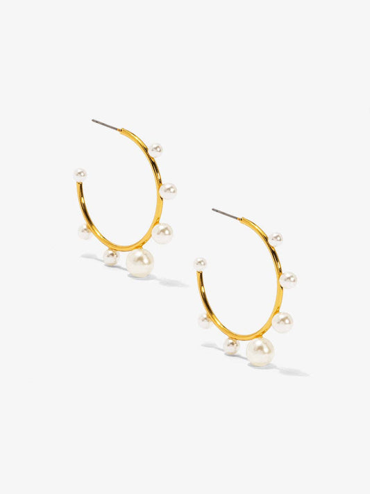Small, gold-tone hoop earring embellished with spaced