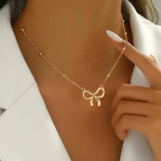 SIMPLE BOW PENDANT NECKLACE: GOLD