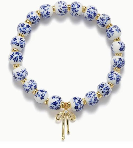 ELEGANT BLUE CERAMIC FLOWER BEADED BRACELET WITH GOLD BOW